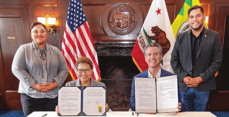 DSA-LA City Council members Eunisses Hernandez and Hugo
                Soto-Martinez stand alongside Governor Gavin Newsom and Mayor
                Karen Bass