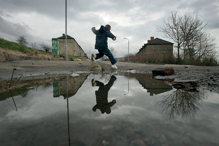 Child in run-down housing estate in Glasgow